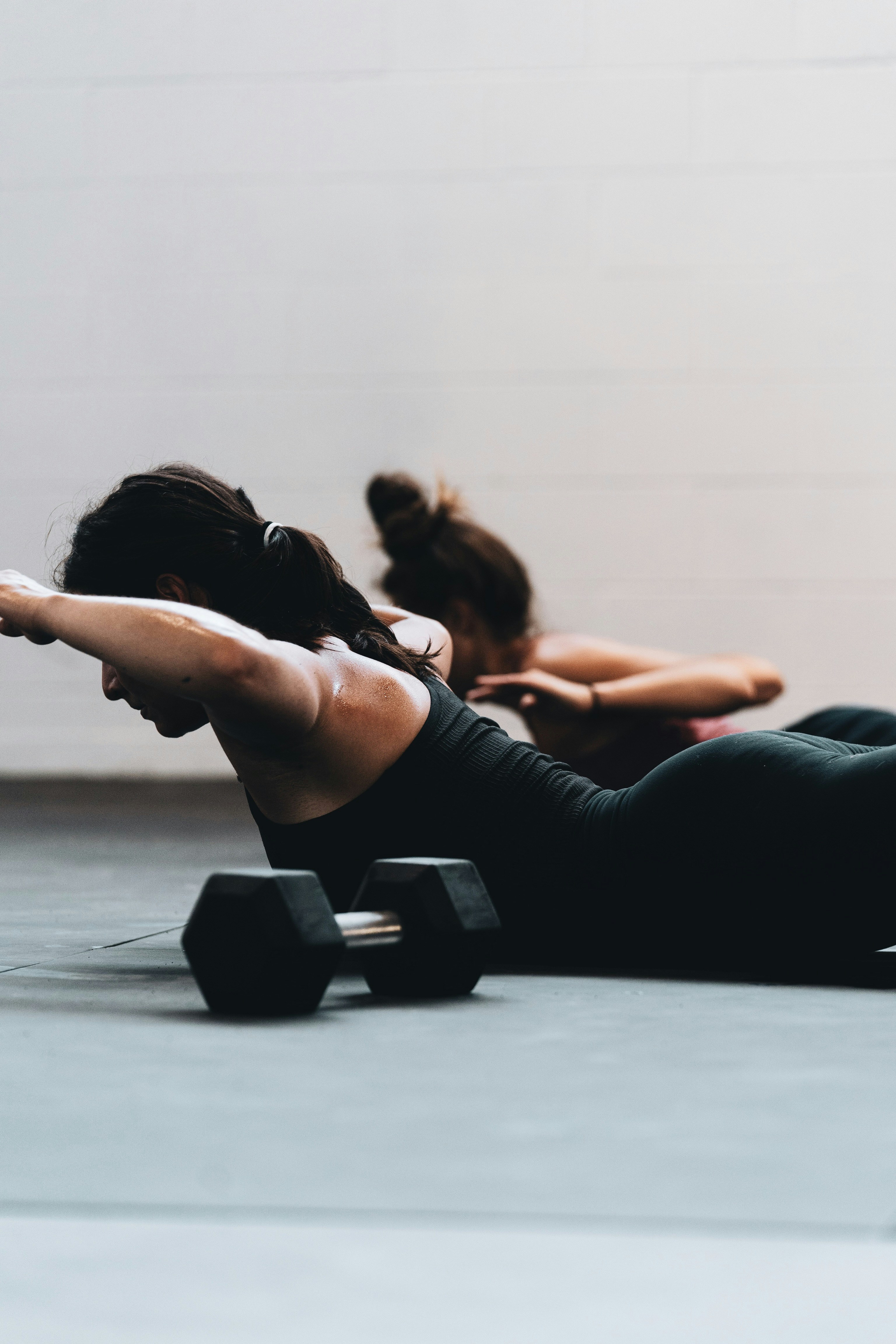 Two women training with a dumbbell